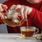 side view of a male pouring tea