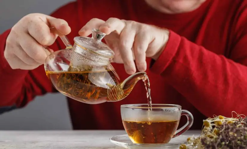 side view of a male pouring tea